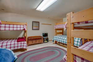 Bedroom featuring a textured ceiling, visible vents, wood finished floors, and baseboards