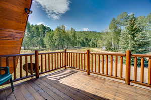 Deck featuring a wooded view
