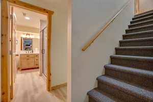 Staircase with visible vents and wood finished floors