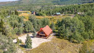 Birds eye view of property with a view of trees