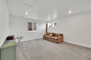 Carpeted living room with attic access, baseboards, and recessed lighting
