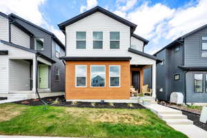 Contemporary house with covered porch and a front lawn
