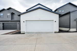 Garage featuring concrete driveway
