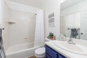 Full bath featuring toilet, shower / tub combo, and vanity