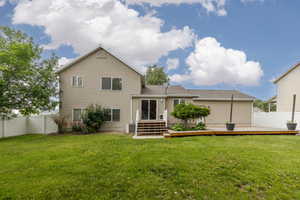 Back of property featuring a deck, roof with shingles, and central AC unit