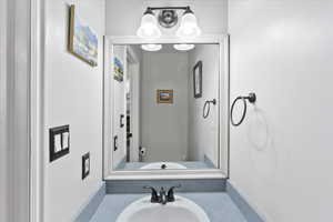 Guest bathroom conveniently located by garage entrance and adjacent to entertaining space