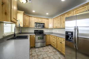Kitchen with a sink, stone finish floor, visible vents, appliances with stainless steel finishes, and recessed lighting