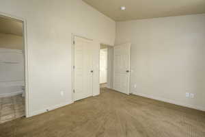 Unfurnished bedroom featuring carpet floors and baseboards