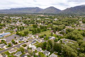Aerial overview of property's location featuring a mountainous background and nearby suburban area