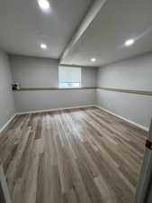Basement featuring recessed lighting, baseboards, and wood finished floors