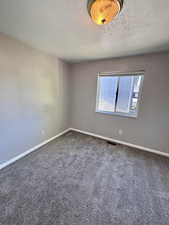 Second bedroom with carpet flooring and freshly painted.
