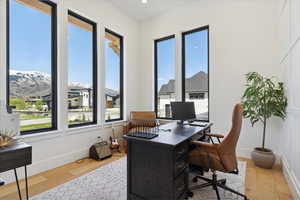 Office area with baseboards and wood finished floors