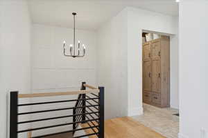 Dining space with a chandelier, baseboards, and brick floor