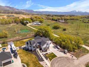 Birds eye view of property with a rural view and a mountain view