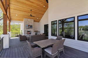 Deck featuring grilling area and an outdoor living space with a fireplace