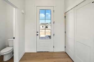 Doorway to outside featuring baseboards and light wood finished floors