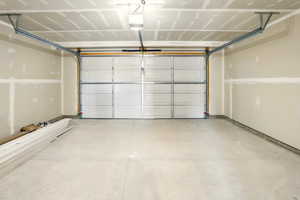 Garage featuring a garage door opener and lifetime warranty