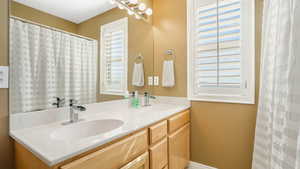 Full bath with a sink and double vanity