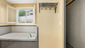 Primary Full bath with a tub with jets