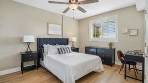 Bedroom featuring baseboards, light wood-style flooring, and ceiling fan
