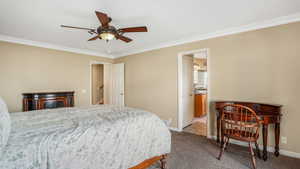 Primary Bedroom with baseboards, ensuite bathroom, crown molding, and carpet floors