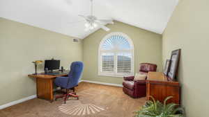 Loft: Carpeted office featuring a ceiling fan, baseboards, visible vents, and lofted ceiling