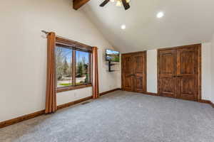 Unfurnished bedroom with lofted ceiling with beams, visible vents, baseboards, light colored carpet, and recessed lighting