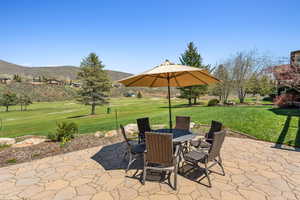 View of patio / terrace with a mountain view, golf course view, and outdoor dining space