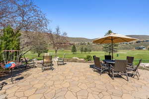 View of patio with outdoor dining area and a mountain view