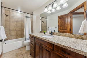 Full bath featuring shower / tub combo, toilet, visible vents, tile patterned floors, and vanity