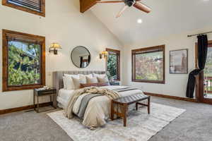 Bedroom with light carpet, baseboards, high vaulted ceiling, and beam ceiling