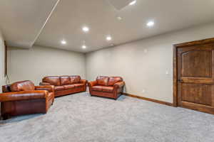 Living room featuring carpet, baseboards, and recessed lighting