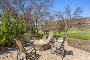 View of patio / terrace with an outdoor fire pit and a mountain view
