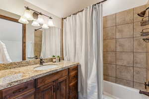 Full bathroom with shower / bath combo and vanity