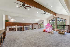 Game room with carpet, a ceiling fan, and vaulted ceiling with beams