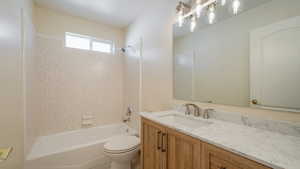 Full bath with washtub / shower combination, vanity, and toilet