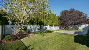 View of yard featuring a fenced backyard and a patio area