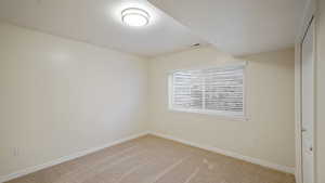 Unfurnished room with baseboards, carpet flooring, and visible vents