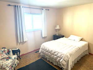 Bedroom featuring baseboards and visible vents