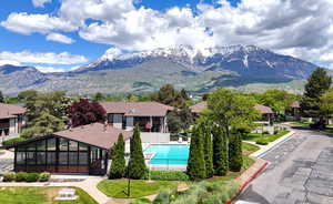 Pool with a mountain view and fence