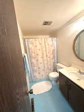 Full bath with finished concrete flooring, vanity, toilet, and visible vents