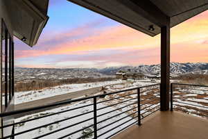 Snow covered back of property featuring a mountain view