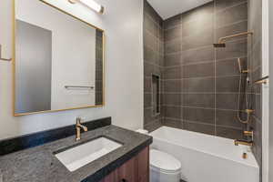 Full bathroom featuring toilet, shower / bathtub combination, and vanity