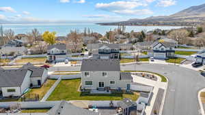Drone / aerial view with a water and mountain view and a residential view