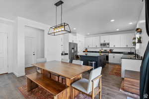 Dining space featuring recessed lighting, baseboards, and dark wood finished floors