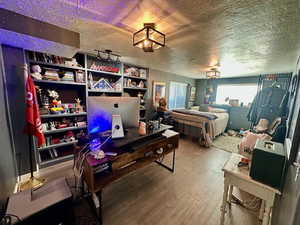 Bedroom featuring a textured ceiling and hardwood / wood-style flooring