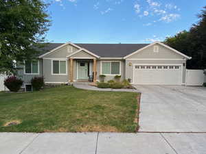 Single story home featuring a garage, driveway, and board and batten siding