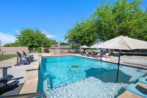 View of pool featuring a patio, fence, and a fenced in pool