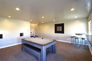 Playroom featuring dark colored carpet, pool table, baseboards, and recessed lighting