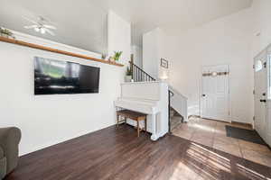Entryway with baseboards, stairs, ceiling fan, and wood finished floors